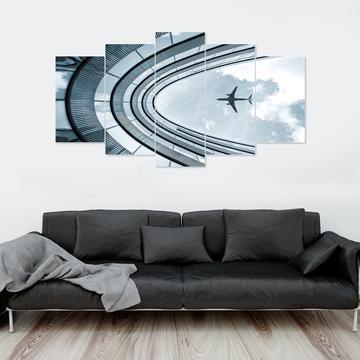 Airplane Flying Over Building – Airplane Canvas Wall Art